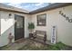 Charming front entrance featuring a decorative bench, potted plants, and a 'Welcome' sign, creating a warm invitation at 24450 Ne 127Th St, Salt Springs, FL 32134