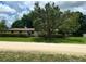 Quaint single-story home featuring mature trees with Spanish Moss and a well-manicured lawn at 24450 Ne 127Th St, Salt Springs, FL 32134