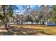 Expansive grounds with mature trees, providing natural beauty and ample space for outdoor activities and waterfront views at 24450 Ne 127Th St, Salt Springs, FL 32134