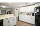 Bright kitchen showcasing white cabinetry, black hardware, and ample counter space at 24450 Ne 127Th St, Salt Springs, FL 32134