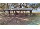 Community pavilion area offering a shaded space for gatherings and outdoor dining, with picnic tables and a grill at 24450 Ne 127Th St, Salt Springs, FL 32134