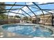 Inviting in-ground screened pool with lounge chairs and clear blue water at 24450 Ne 127Th St, Salt Springs, FL 32134