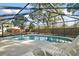 A bright screened pool with lounge seating and views of the fenced yard at 24450 Ne 127Th St, Salt Springs, FL 32134