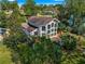 Aerial view of two story house with large deck and surrounding landscape at 2450 Topping Pl, Eustis, FL 32726