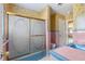 Retro style bathroom with pink and blue tile and shower at 2450 Topping Pl, Eustis, FL 32726