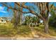 Landscaped front yard with mature trees and brick walkway at 2450 Topping Pl, Eustis, FL 32726