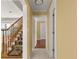 Bright hallway with hardwood floors and access to staircase at 2450 Topping Pl, Eustis, FL 32726