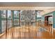 High-ceiling living room with wall of windows and hardwood floors at 2450 Topping Pl, Eustis, FL 32726