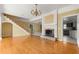 Living room with hardwood floors, fireplace and kitchen view at 2450 Topping Pl, Eustis, FL 32726