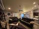 Spacious living room with leather sofas and a ceiling fan at 2613 Crest Dr, Haines City, FL 33844