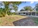 Lush backyard featuring a screened-in pool and mature trees at 2667 Northland Rd, Mount Dora, FL 32757