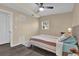 Bedroom featuring ceiling fan, neutral walls, gray floors, area rug, and a view out of the window at 2667 Northland Rd, Mount Dora, FL 32757