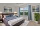 Staged bedroom with a cozy bed, stylish decor, and a view to the outdoors at 284 Pelchat Pl, The Villages, FL 32163