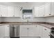 Kitchen featuring stainless steel appliances, laminate floor, white cabinets, and contrasting hardware at 284 Pelchat Pl, The Villages, FL 32163