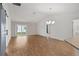 Open living space featuring laminate floors, barn door, and a sliding glass door to a patio at 284 Pelchat Pl, The Villages, FL 32163