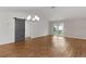 Bright living space featuring laminate flooring, neutral paint, chandelier and a barn door at 284 Pelchat Pl, The Villages, FL 32163