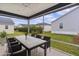 Inviting screened patio with dining furniture set and view of the landscaped backyard at 284 Pelchat Pl, The Villages, FL 32163