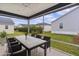 Relaxing screened-in patio with dining set, ceiling fan, and views of the backyard at 284 Pelchat Pl, The Villages, FL 32163