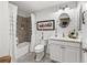 Elegant bathroom with a white vanity, gray tile, and decorative accents at 2987 Schoenacher St, The Villages, FL 32163