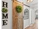 Charming hallway with a rustic barn door and decorative wall art at 2987 Schoenacher St, The Villages, FL 32163