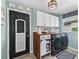 Laundry room with wooden countertop, front load washer and dryer, and farmhouse style at 2987 Schoenacher St, The Villages, FL 32163