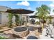 Fire pit and patio seating area with umbrellas at 2987 Schoenacher St, The Villages, FL 32163