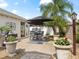 Outdoor patio dining area with black umbrellas at 2987 Schoenacher St, The Villages, FL 32163