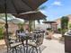 Patio furniture under umbrellas, perfect for outdoor dining at 2987 Schoenacher St, The Villages, FL 32163