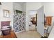 Bathroom features a shower with floral curtain and open view to main bedroom at 3001 Saint Thomas Ln, The Villages, FL 32162