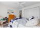 Cozy bedroom featuring ceiling fan, dresser, and closet at 3001 Saint Thomas Ln, The Villages, FL 32162
