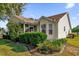 Charming home exterior with manicured bushes and well-defined yard edging at 3001 Saint Thomas Ln, The Villages, FL 32162