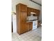 Kitchen featuring wood cabinets and white appliances, including a gas range at 3001 Saint Thomas Ln, The Villages, FL 32162
