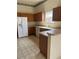 Spacious kitchen featuring wood cabinets, white appliances, and ample counter space at 3001 Saint Thomas Ln, The Villages, FL 32162