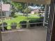 Serene screened patio view of a lush green lawn and well-kept neighborhood at 3001 Saint Thomas Ln, The Villages, FL 32162