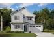 Two-story home with light gray siding, teal door, and attached garage at 3083 Prospect Trl, St Cloud, FL 34771