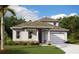 Charming one-story home with covered porch, attached garage, well-maintained lawn, and lush landscaping at 3083 Prospect Trl, St Cloud, FL 34771