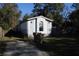 Mobile home exterior with a yard and surrounding trees at 31735 S Lake Dr, Eustis, FL 32736