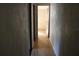 Long hallway with light wood flooring connecting rooms at 31735 S Lake Dr, Eustis, FL 32736