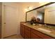 Double vanity bathroom with granite countertop and large mirror at 3180 Dressendorfer Dr, The Villages, FL 32163