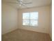 Well-lit bedroom featuring carpeted floor and a large window at 3180 Dressendorfer Dr, The Villages, FL 32163