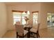 Bright breakfast nook with a glass table and four chairs at 3180 Dressendorfer Dr, The Villages, FL 32163