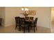 Dining area with a dark-wood table, six chairs, and a chandelier at 3180 Dressendorfer Dr, The Villages, FL 32163