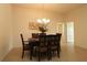 Dining area with a dark-wood table, six chairs, and a chandelier at 3180 Dressendorfer Dr, The Villages, FL 32163