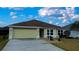 Front view of house with attached garage and landscaping at 3180 Dressendorfer Dr, The Villages, FL 32163