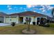 Front view of house with attached garage and landscaping at 3180 Dressendorfer Dr, The Villages, FL 32163