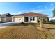 Front view of house with attached garage and landscaping at 3180 Dressendorfer Dr, The Villages, FL 32163