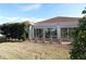 House exterior showcasing sunroom and well-maintained lawn at 3180 Dressendorfer Dr, The Villages, FL 32163