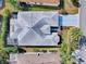 Aerial view of the house and surrounding neighborhood, highlighting the roof, screened porch and landscaping at 320 Rhapsody Path, The Villages, FL 32162