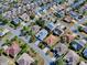 This aerial image highlights the home's landscaping in a desirable neighborhood with mature trees and well-maintained lawns at 320 Rhapsody Path, The Villages, FL 32162