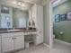 Bathroom featuring a sink with a vanity and attached shelving and cabinet space at 320 Rhapsody Path, The Villages, FL 32162